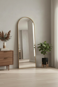Arch floor mirror with gold frame in minimalist bedroom