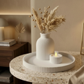 White ribbed set with cotton stems on terrazzo table warm evening light