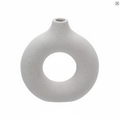 White ceramic donut ring vase on white background